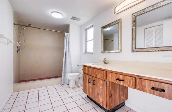 a bathroom with a sink a toilet and mirror