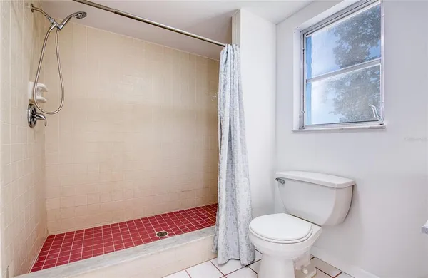 an empty room with closet and a bathroom