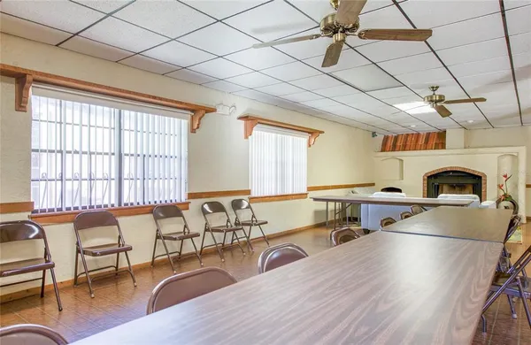 a living room with furniture a dining table and chairs with wooden floor