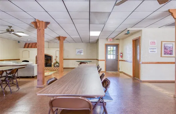a room with pool table and windows
