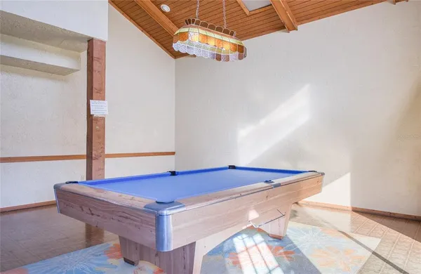 a kitchen with cabinets and wooden floor