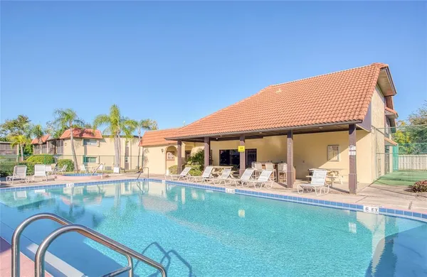 a view of a patio with swimming pool table and chairs