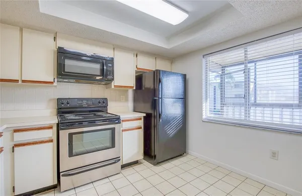 a kitchen with a stove microwave and refrigerator