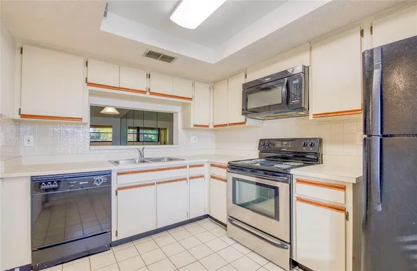 a kitchen with a stove sink and refrigerator