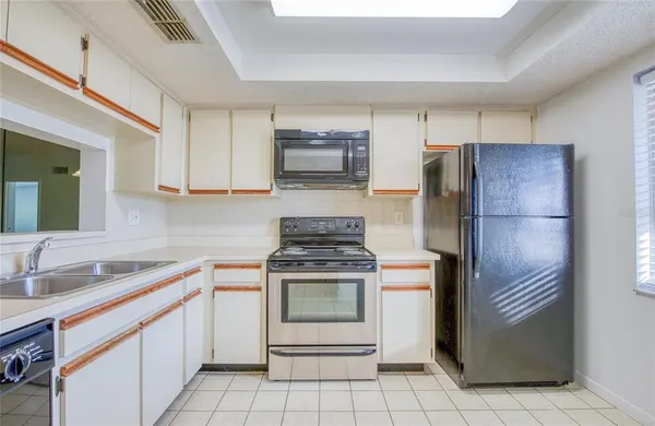 a kitchen with a stove sink and refrigerator