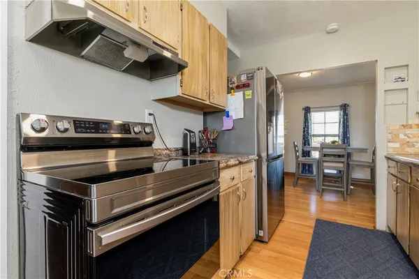 a kitchen with stainless steel appliances kitchen island a stove and a refrigerator