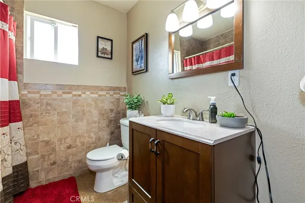 a bathroom with a sink mirror vanity and toilet