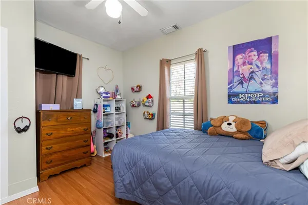 a bedroom with a bed and wooden floor