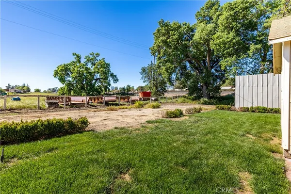 a view of swimming pool with lawn chairs and plants