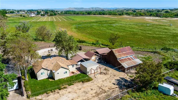an aerial view of a house with garden space and ocean view