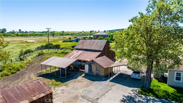 an aerial view of a house with garden space and street view