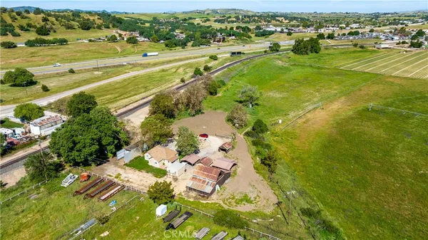 an aerial view of residential houses with outdoor space and ocean view