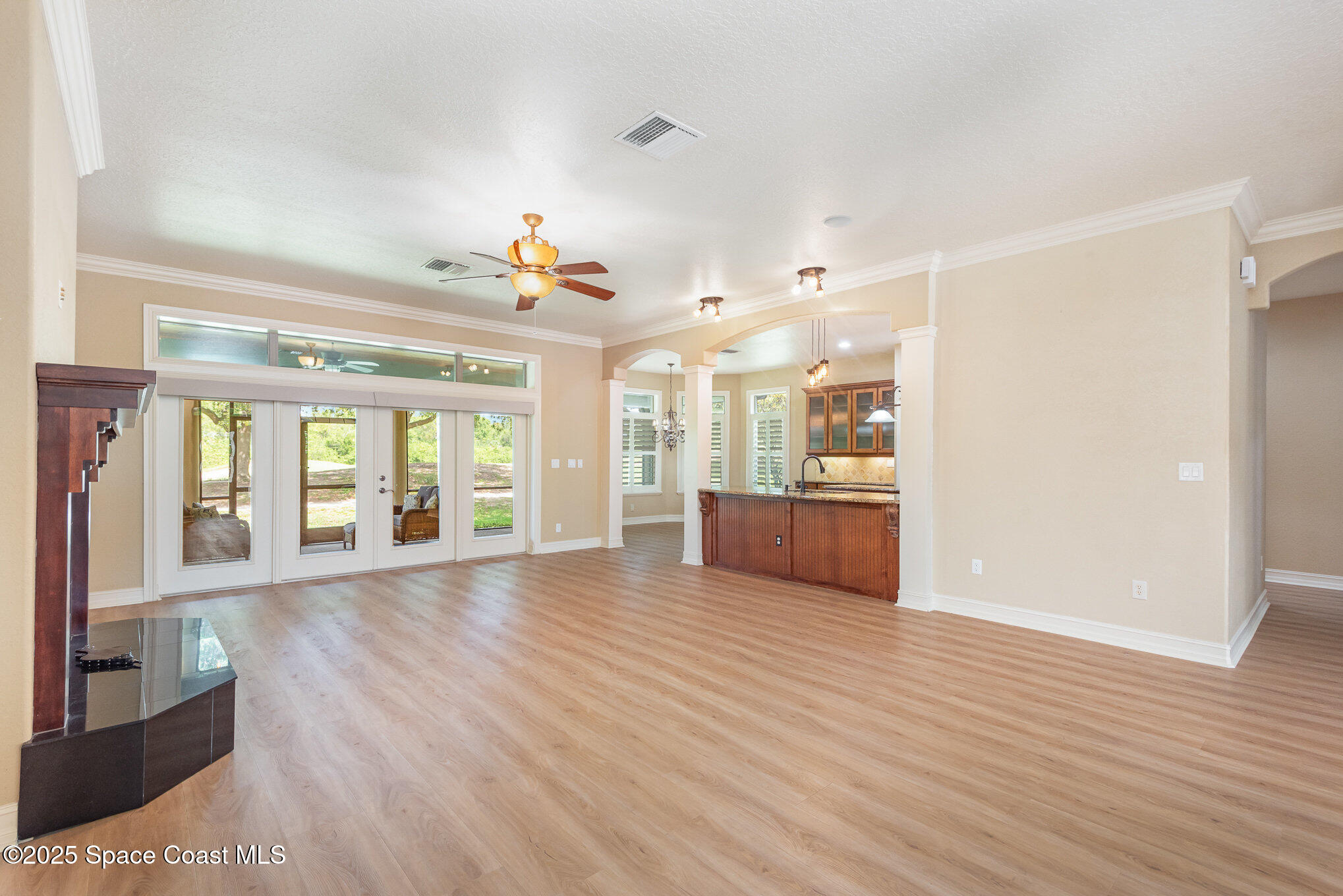 3260 Quantum Place Mims, FL 32754 - Photo 12 of 43 a view of a big room with wooden floor and windows