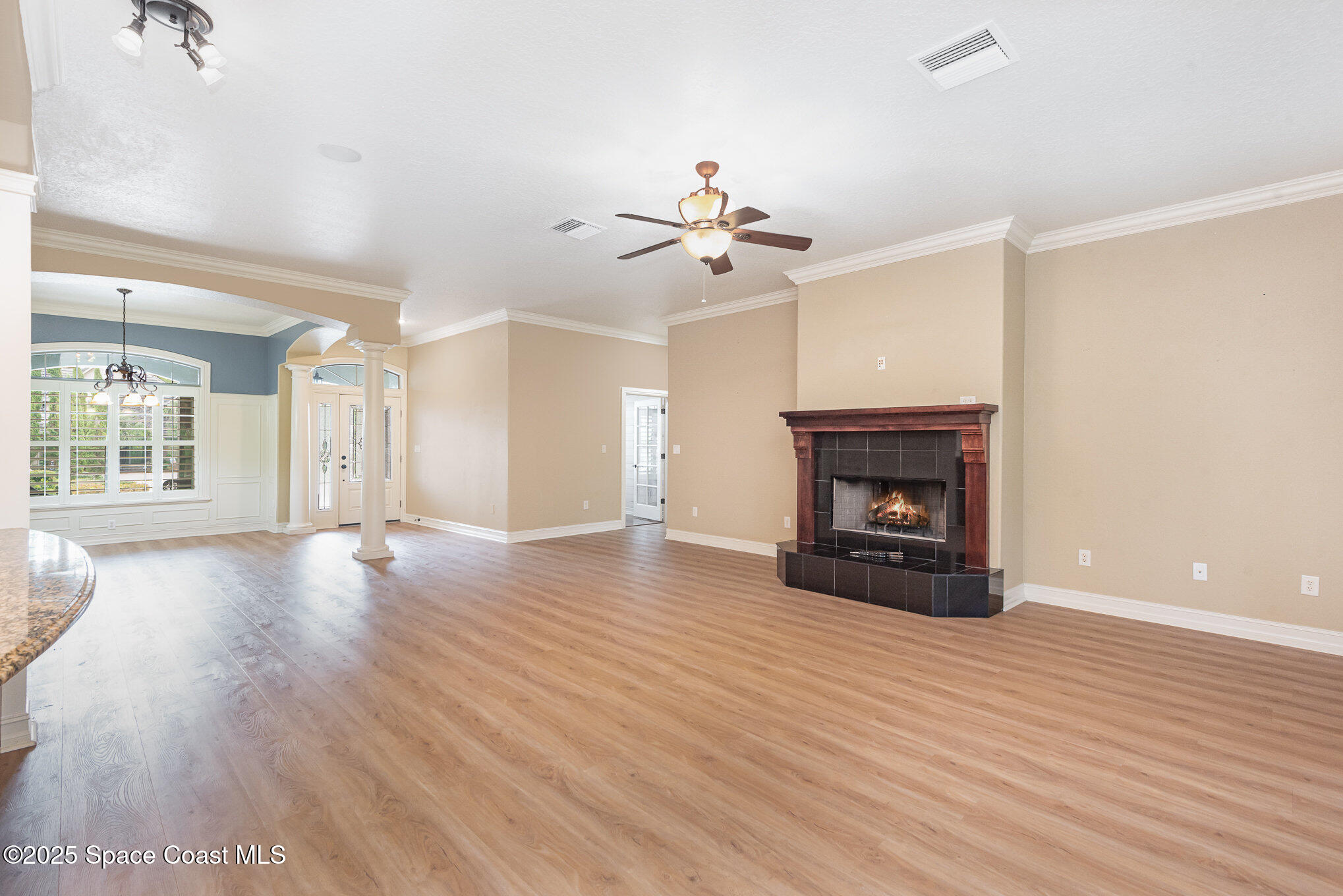 3260 Quantum Place Mims, FL 32754 - Photo 14 of 43 a view of an empty room with a fireplace and a window