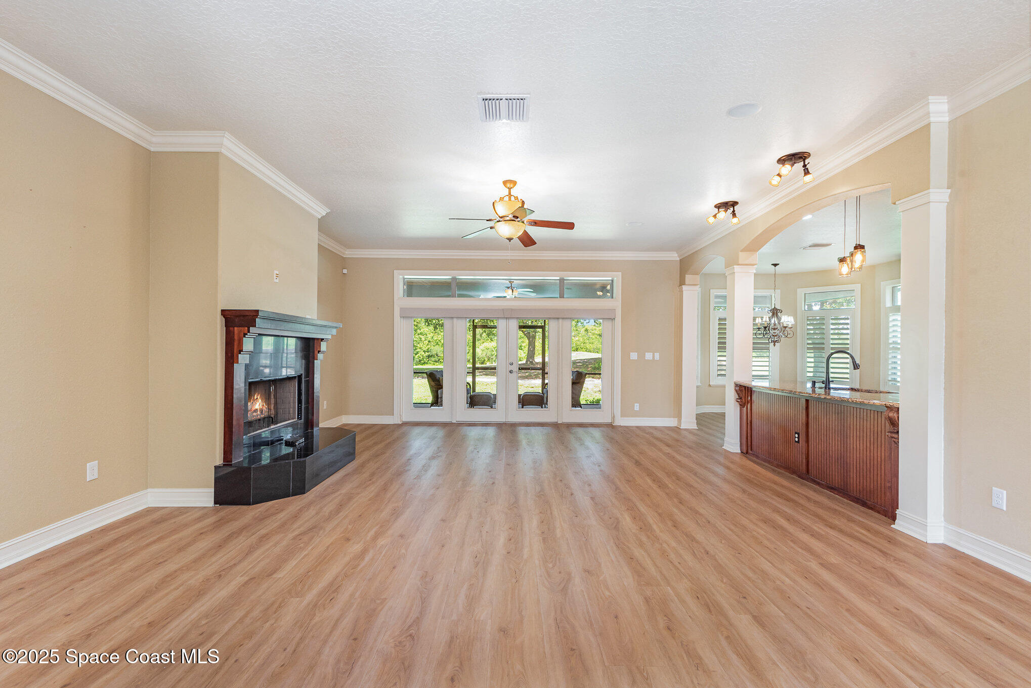 3260 Quantum Place Mims, FL 32754 - Photo 15 of 43 a view of an empty room with wooden floor fireplace and a window