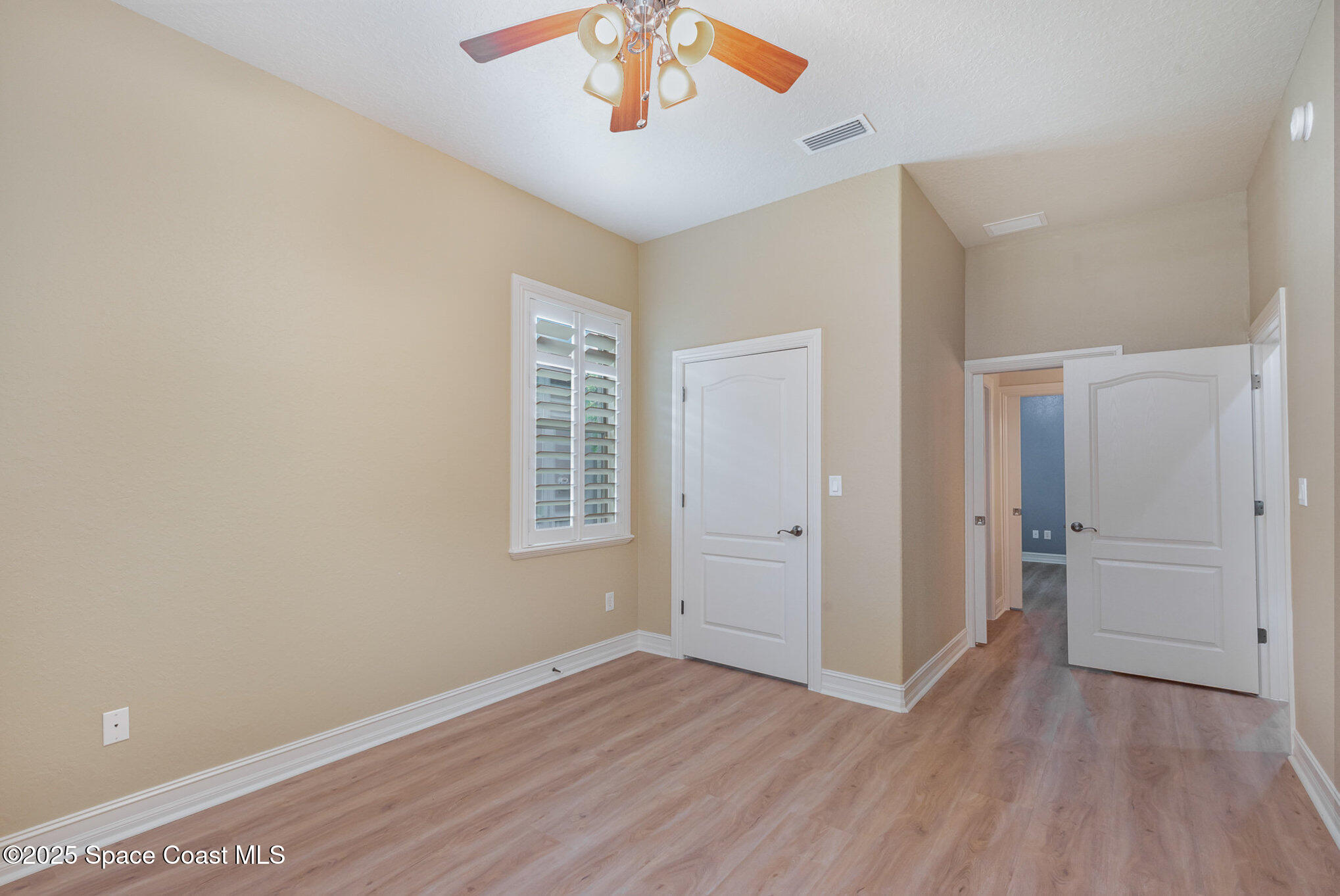 3260 Quantum Place Mims, FL 32754 - Photo 23 of 43 wooden floor in an empty room with a window