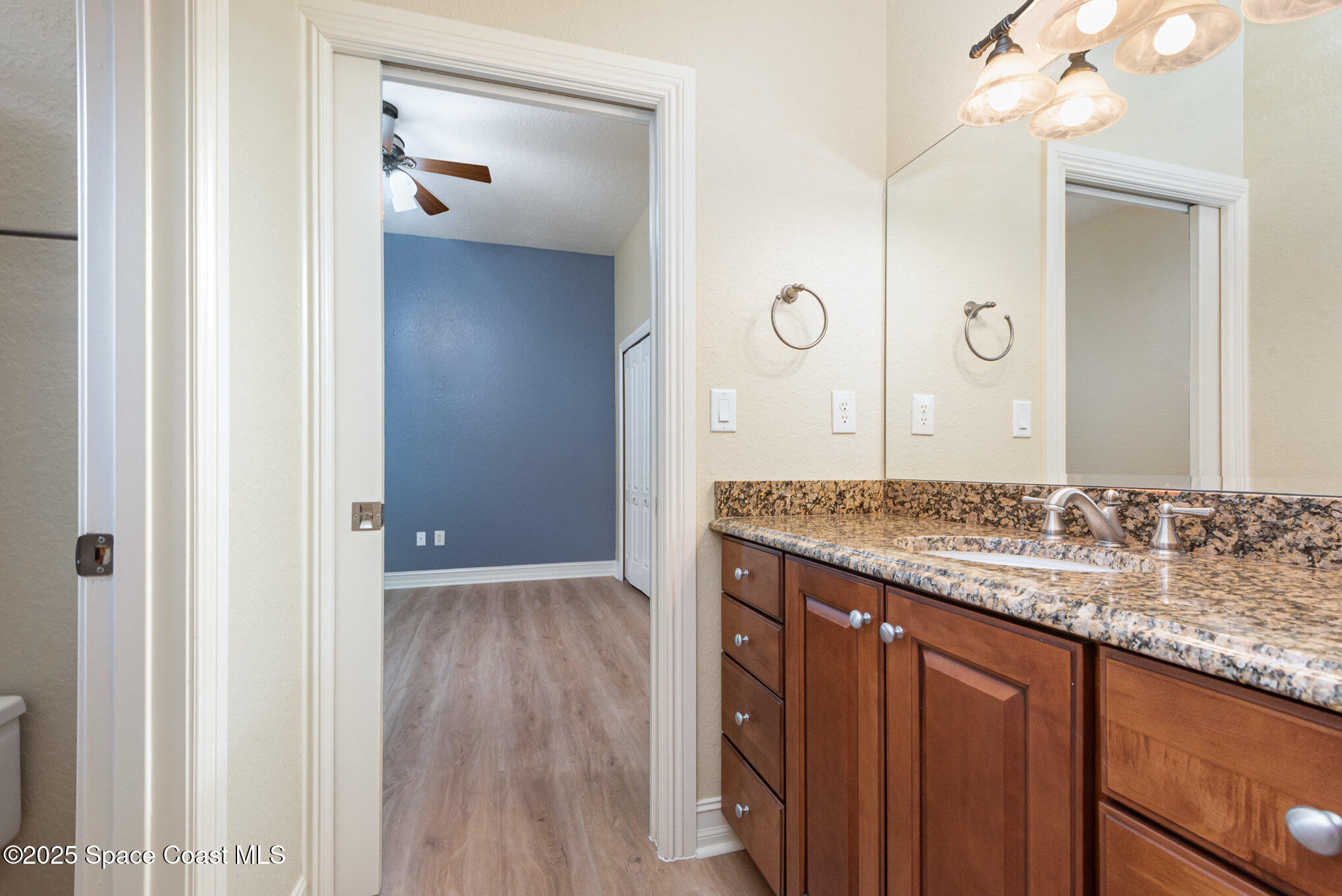 3260 Quantum Place Mims, FL 32754 - Photo 25 of 43 a bathroom with a granite countertop sink and a mirror