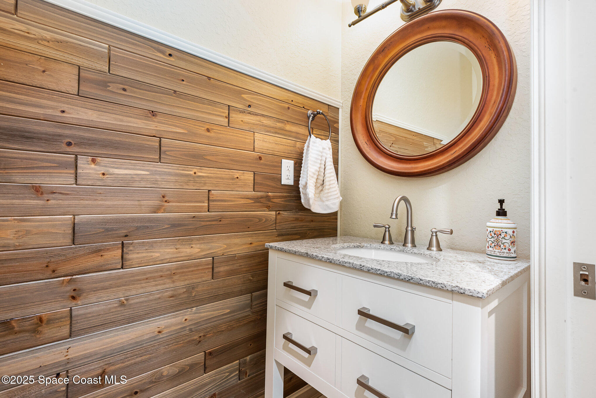 3260 Quantum Place Mims, FL 32754 - Photo 29 of 43 a bathroom with a sink and a mirror