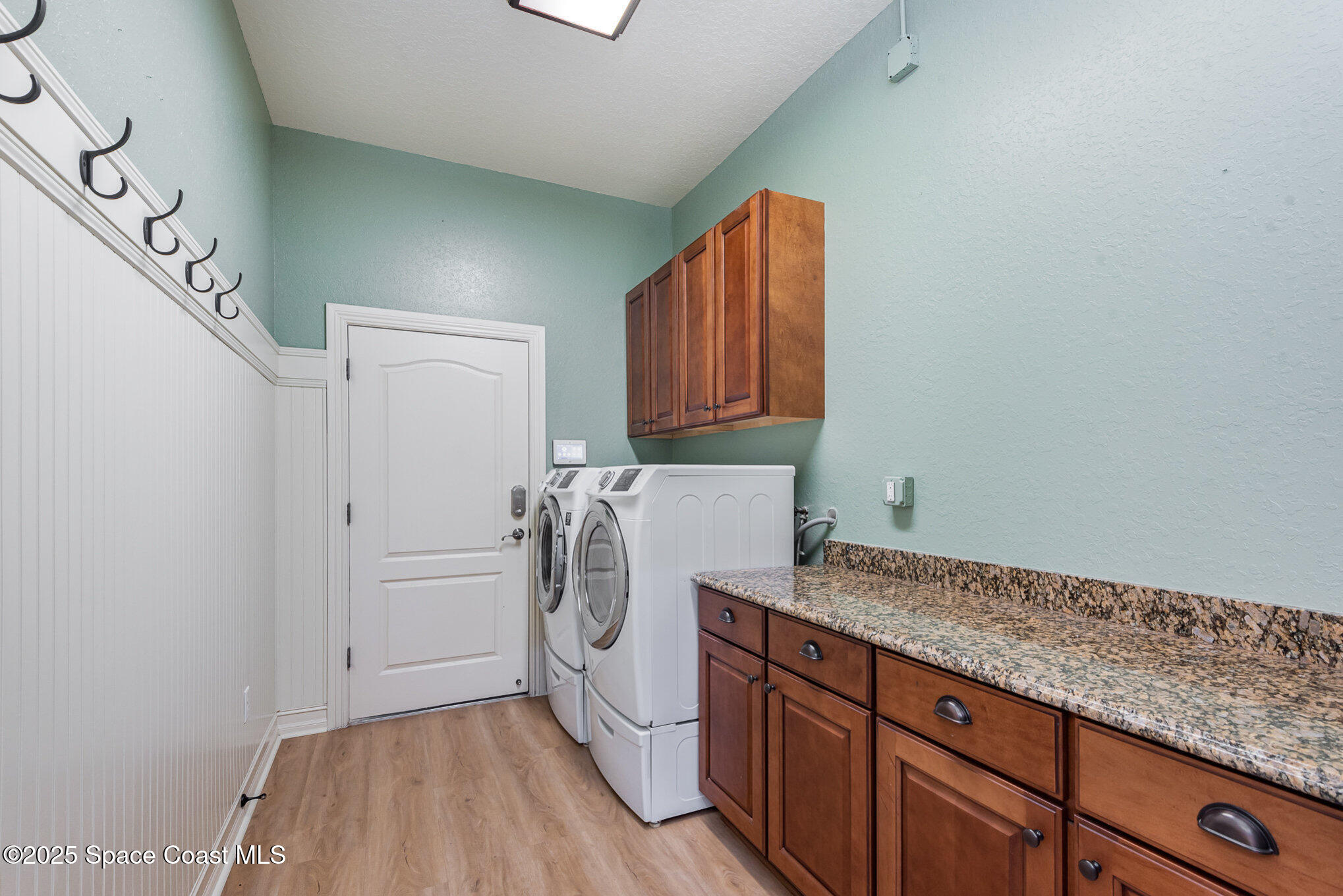 3260 Quantum Place Mims, FL 32754 - Photo 30 of 43 a utility room with granite countertop a sink a washer and dryer