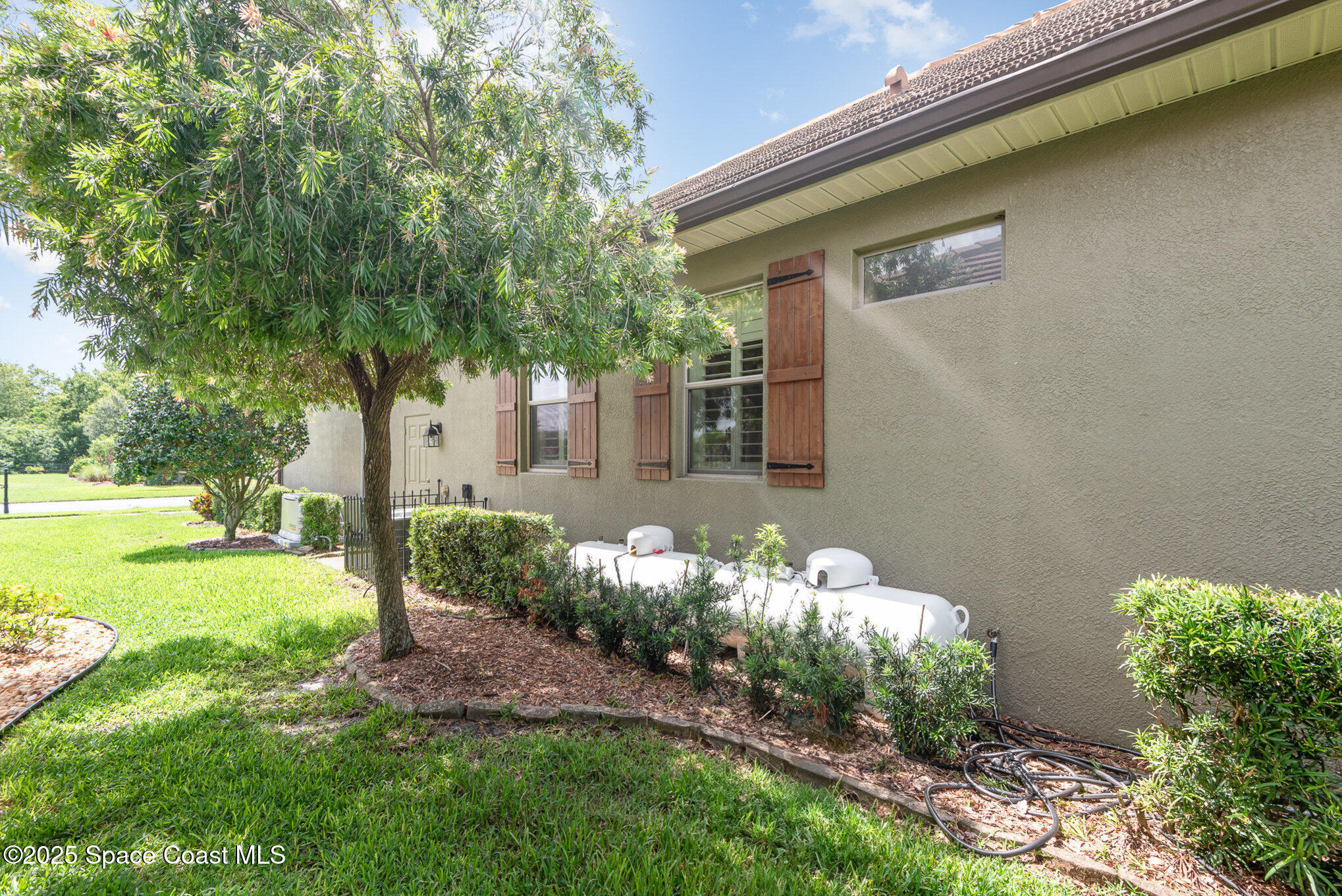 3260 Quantum Place Mims, FL 32754 - Photo 33 of 43 a front view of a house with garden