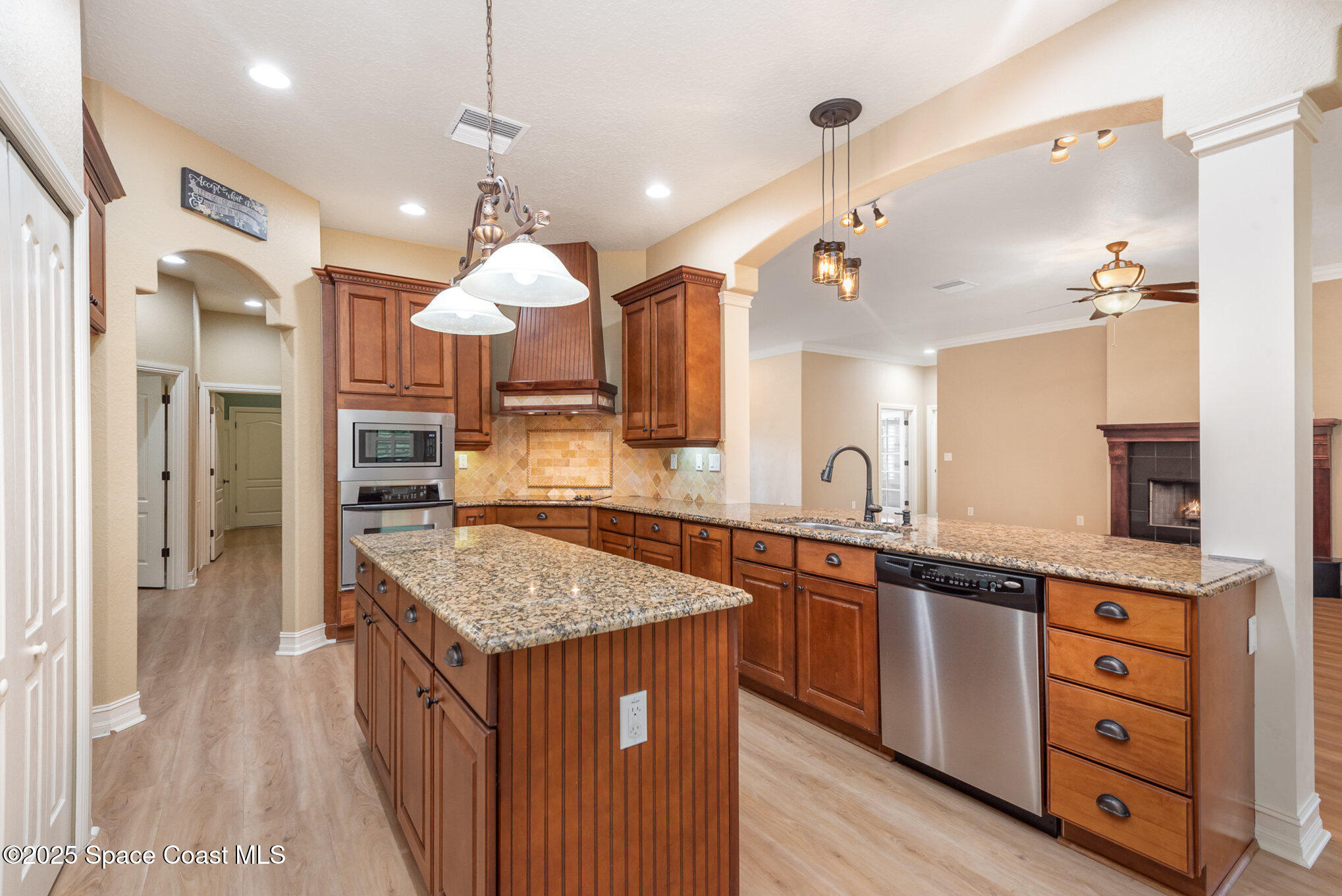 3260 Quantum Place Mims, FL 32754 - Photo 7 of 43 a kitchen with kitchen island granite countertop a stove and a sink
