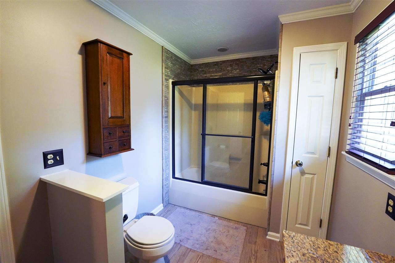 1327 Hyndsver Road Martin, TN 38237 - Photo 8 of 17 a bathroom with a toilet a sink and a mirror