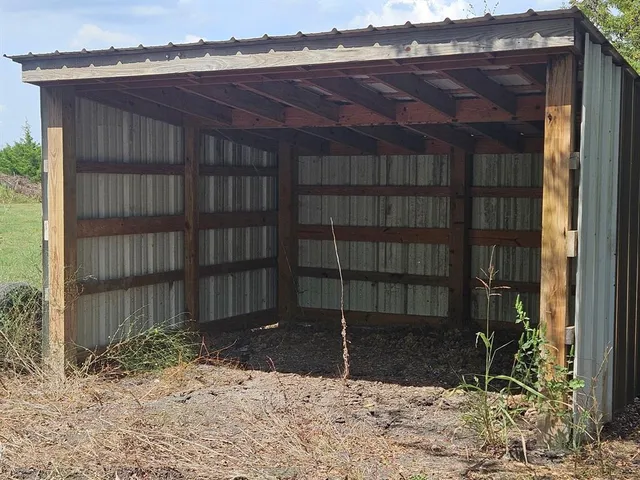a view of a field with trees in background