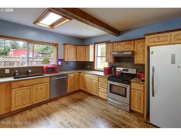 a kitchen with sink a window and cabinets