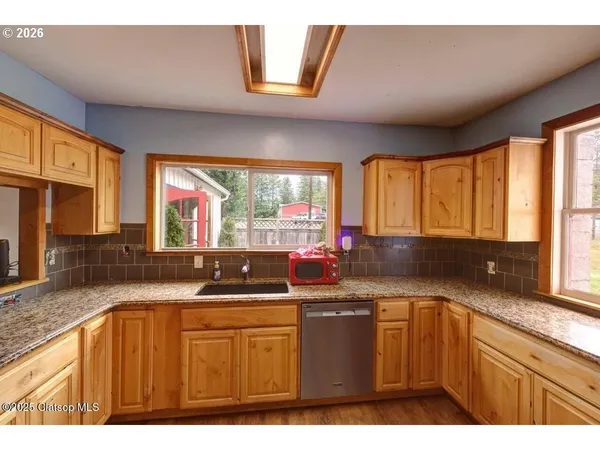 a view of a kitchen with a sink and a refrigerator