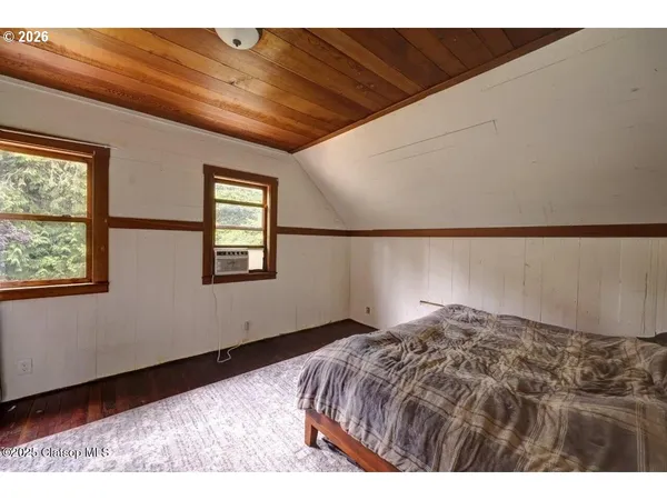 a bedroom with a bed and a television