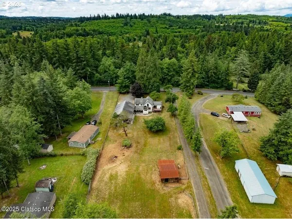 an aerial view of a house with swimming pool garden and patio