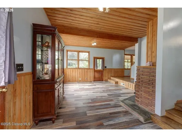 a view of entryway and hall with wooden floor