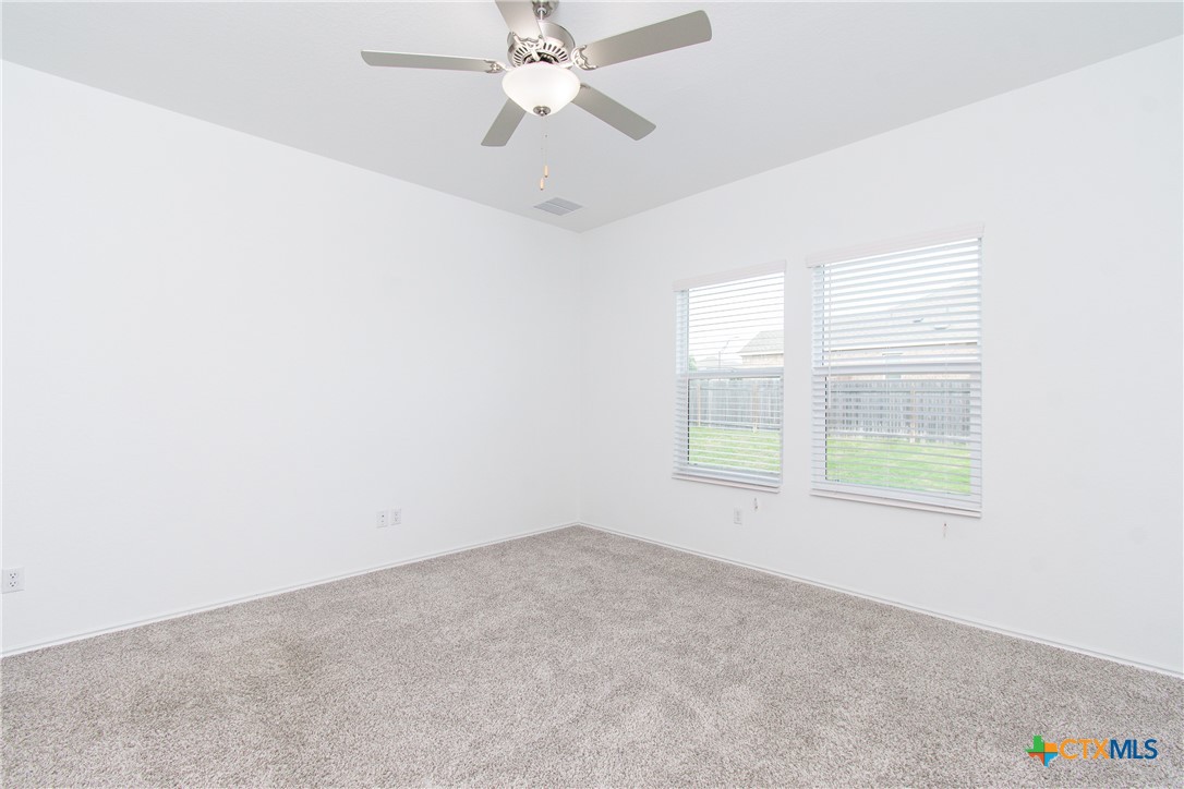 9101 Daisy Cutter Crossing Georgetown, TX 78626 - Photo 25 of 28 an empty room with a window and a fan