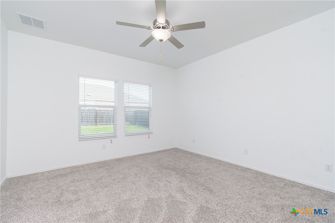 9101 Daisy Cutter Crossing Georgetown, TX 78626 - Photo 26 of 28 an empty room with a window and a ceiling fan