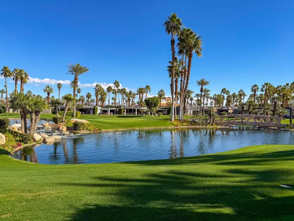 a view of a lake with houses in the background