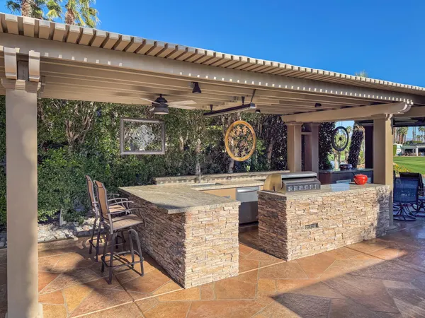 a view of a chairs and table in the patio