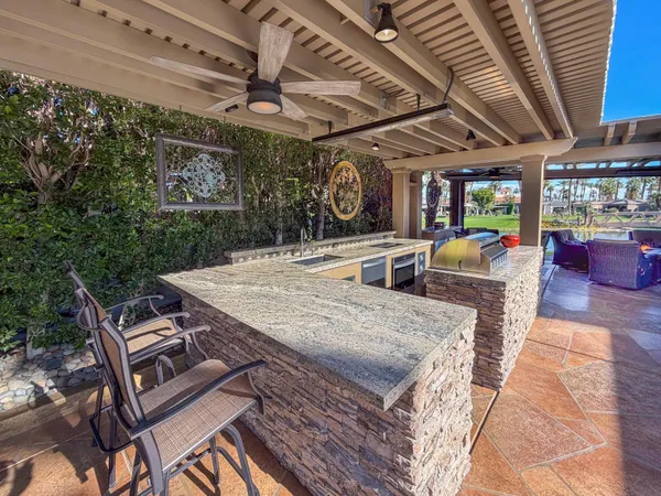 a view of a patio with table and chairs with wooden floor