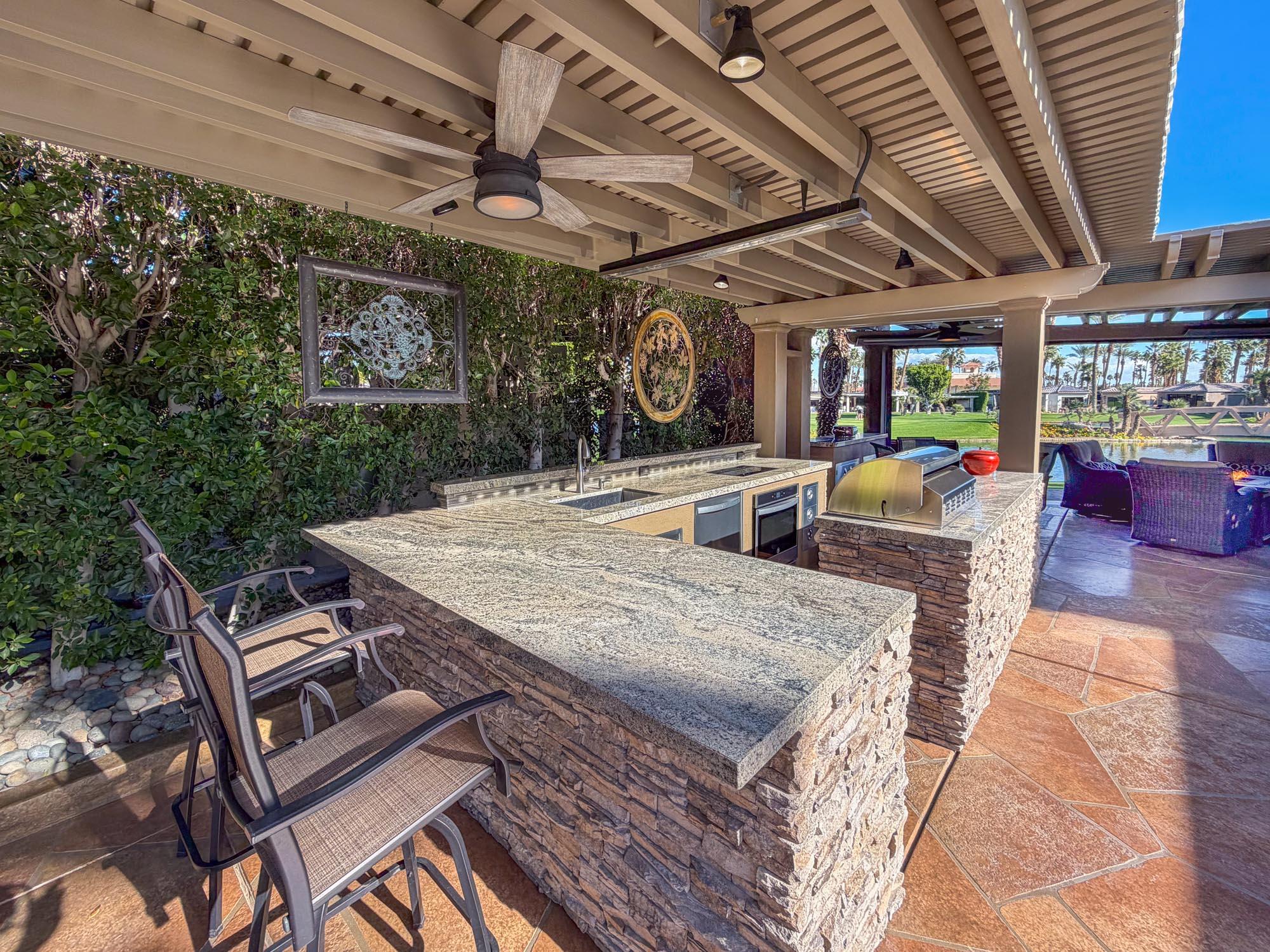 80394 Ave 48, Unit 321 Indio, CA 92201 - Photo 3 of 20 a view of a patio with table and chairs with wooden floor
