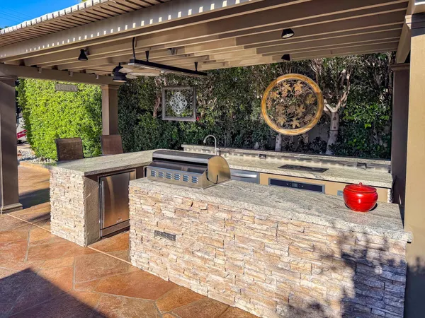 a view of a room with a wooden floor and a fireplace