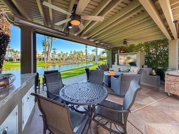a view of a patio with a table chairs and a patio