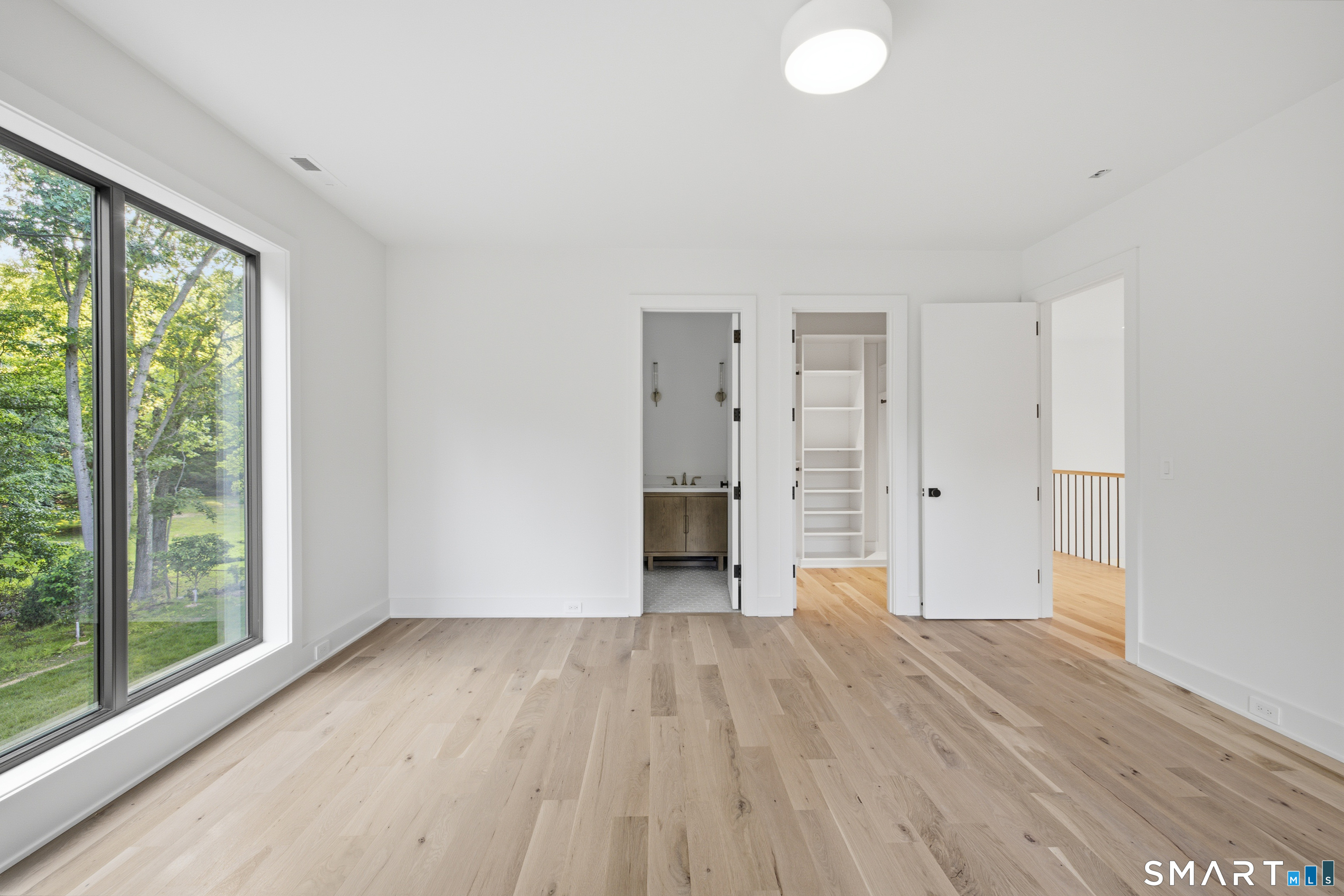 2 Windy Hill Road Westport, CT 06880 - Photo 25 of 40 a view of empty room with wooden floor and fan