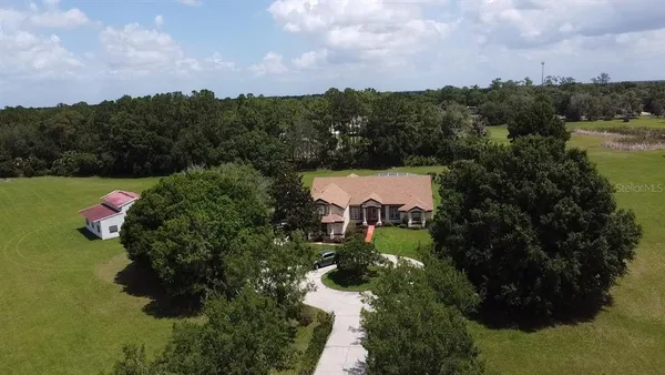 an aerial view of a house with yard