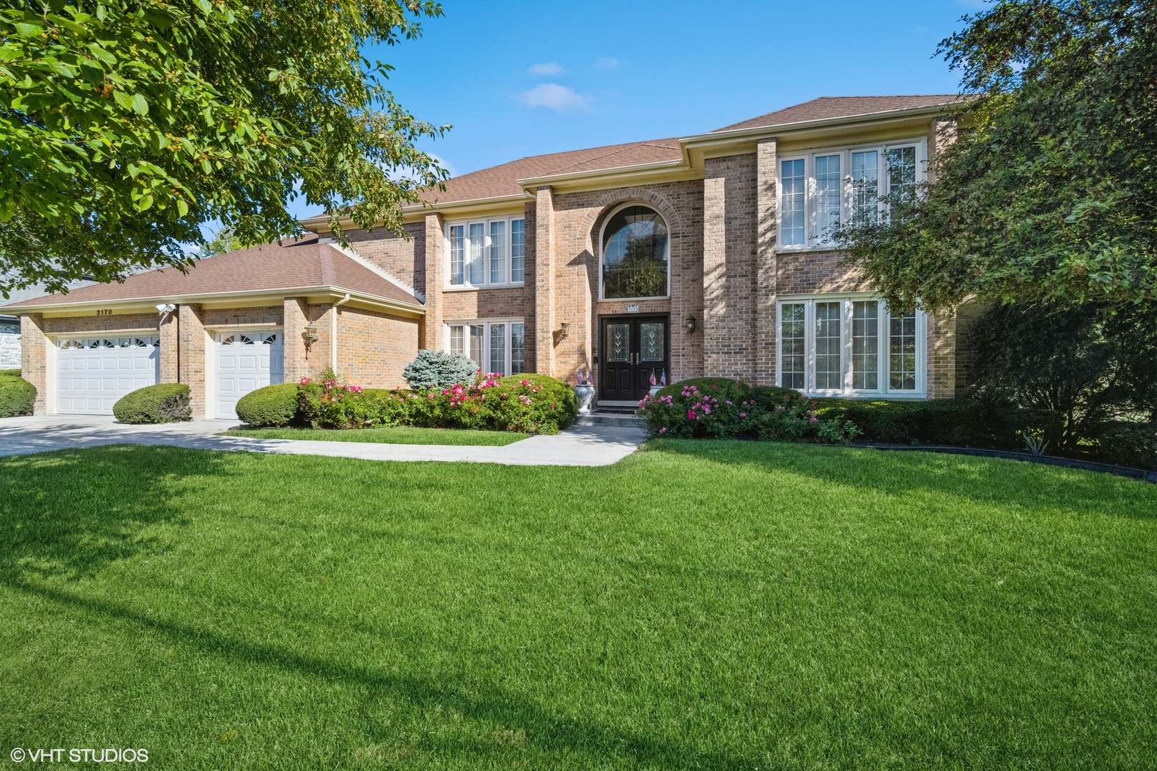 3170 Keystone Road Northbrook, IL 60062 - Photo 1 of 42 a front view of a house with garden and trees