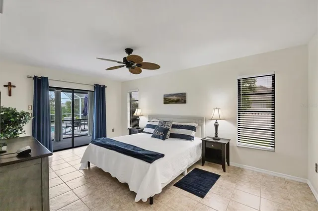 a spacious bedroom with a large bed and a chandelier