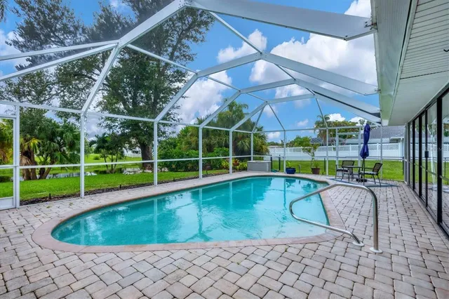 a view of a backyard with a swimming pool