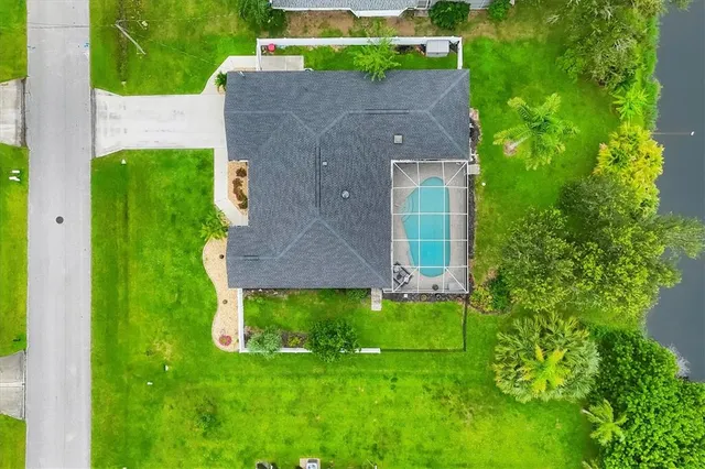 a front view of a house with a garden and yard