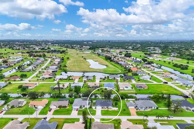 a view of a lake with a swimming pool and outdoor seating