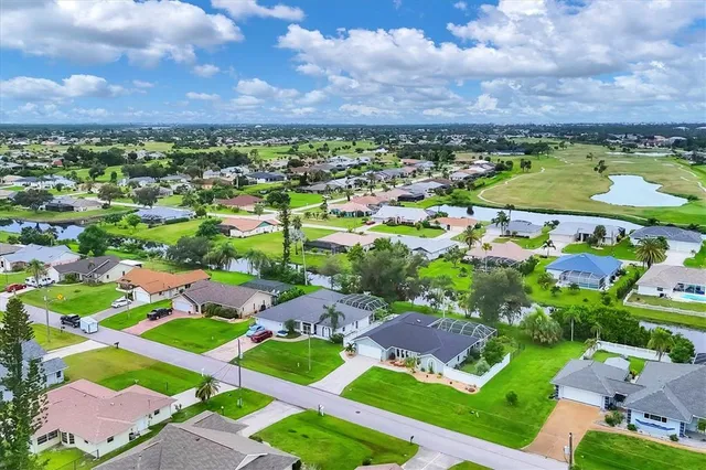 an aerial view of residential houses with outdoor space