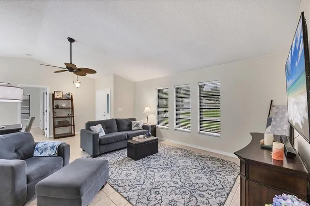 a living room with furniture a window and a flat screen tv