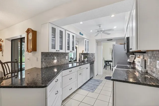 a kitchen with stainless steel appliances granite countertop a sink stove and cabinets
